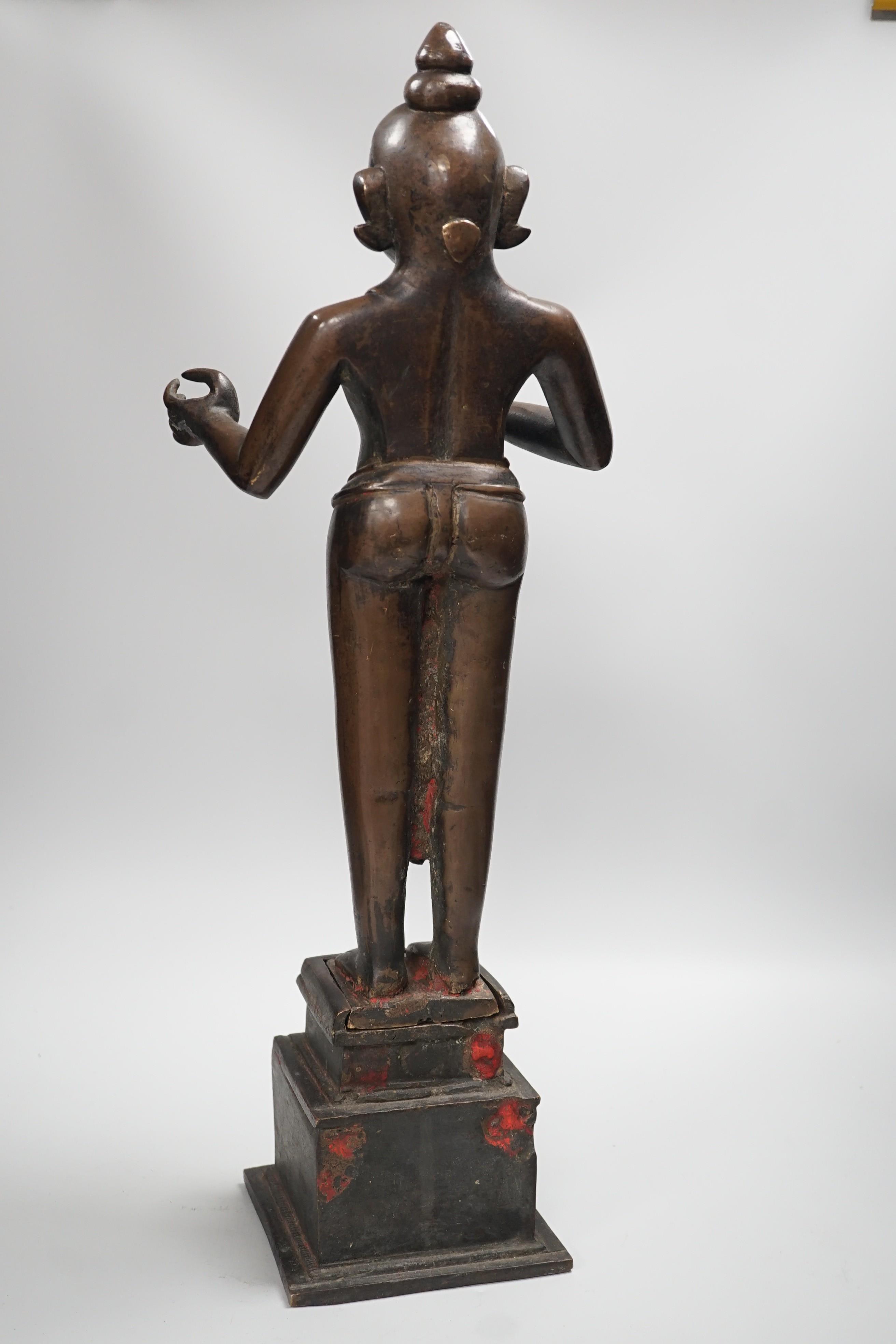 A large and heavy 19th century Indian bronze figure of Radha with separate bronze pedestal, total height 56cm